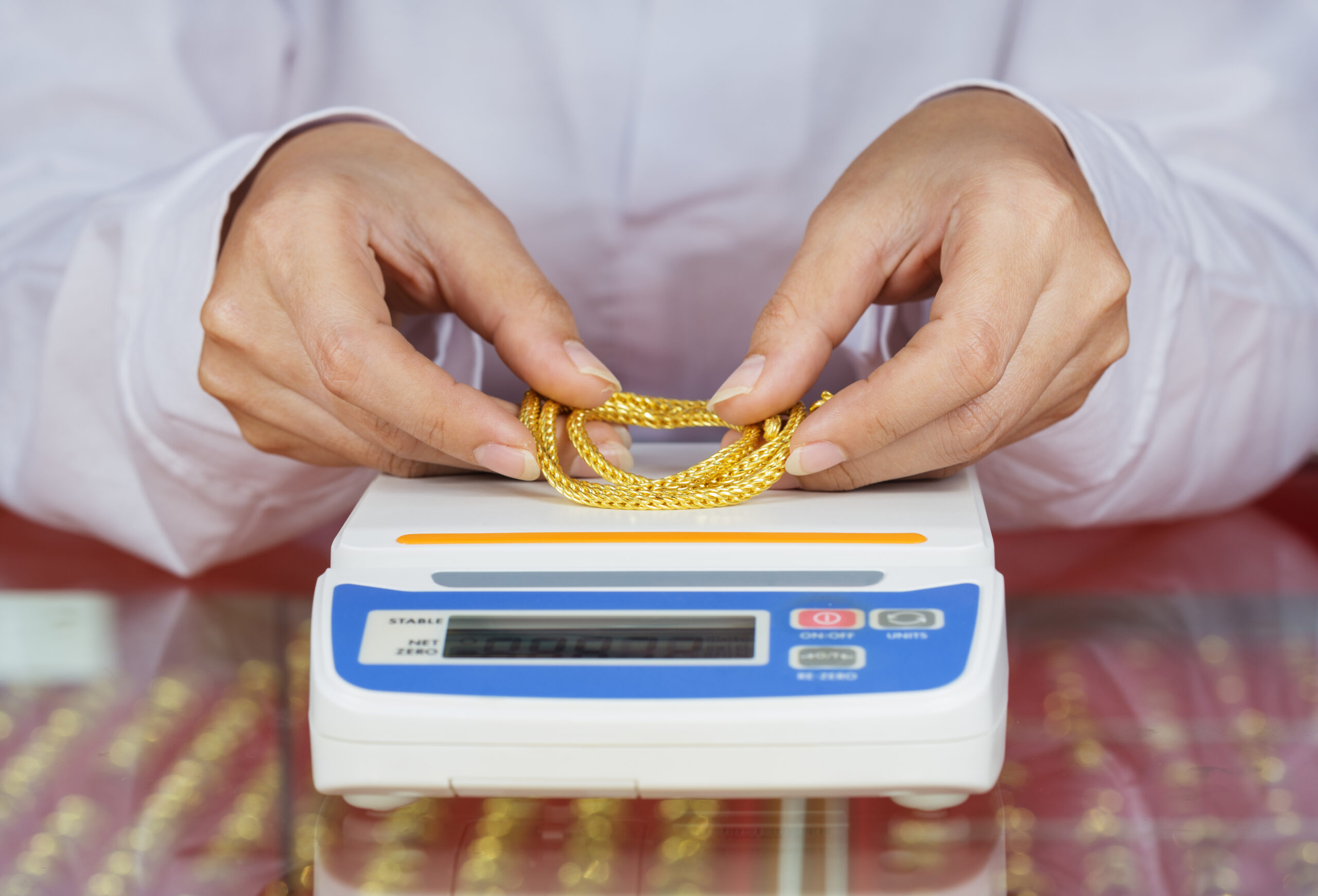 digital-scales-weighing-gold-rings-necklaces-with-hand