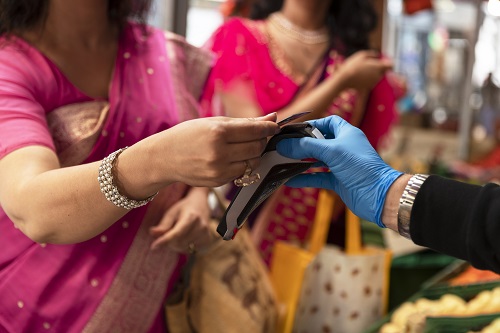 side-view-woman-paying-groceries